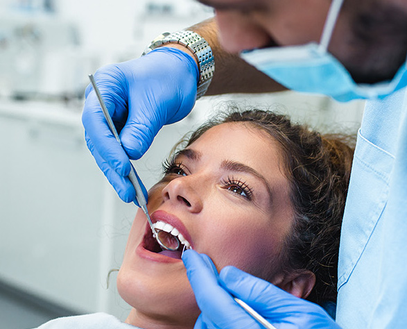 Dentist performing a root canal procedure on a patient to relieve pain and preserve the tooth.