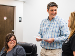 Dental team member assisting a patient during an emergency dental care visit