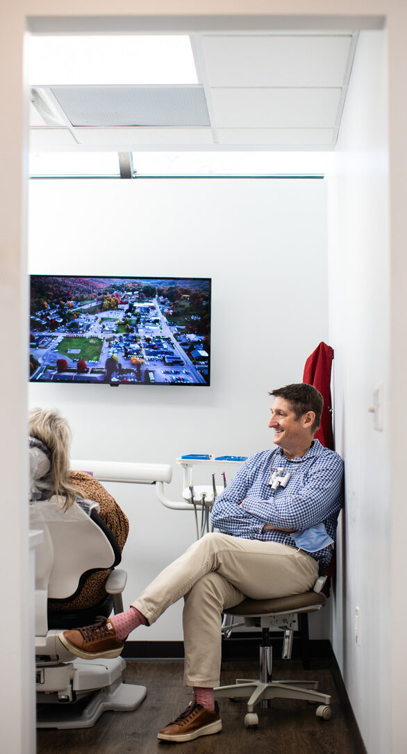 Dentist showing a patient her tooth scan before designing a same day crown