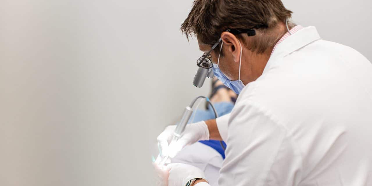 Dentist performing a detailed bonding procedure on a patient