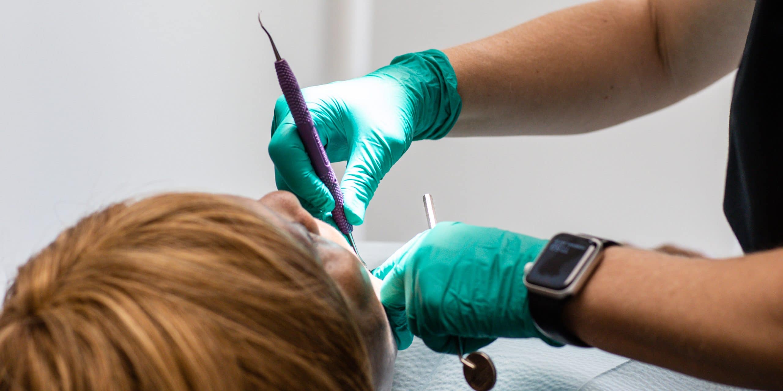 Dental hygienist preparing tools for a general dentistry cleaning and checkup