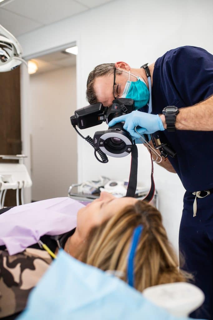 Dentist preparing a patient for dental implants treatment