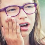 Woman reacting to traditional braces to highlight Invisalign’s wire-free design