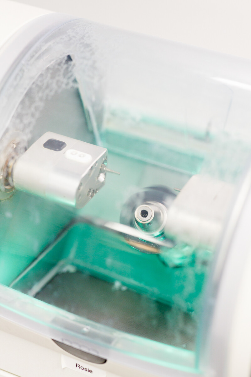 CEREC machine milling a custom porcelain dental crown in office