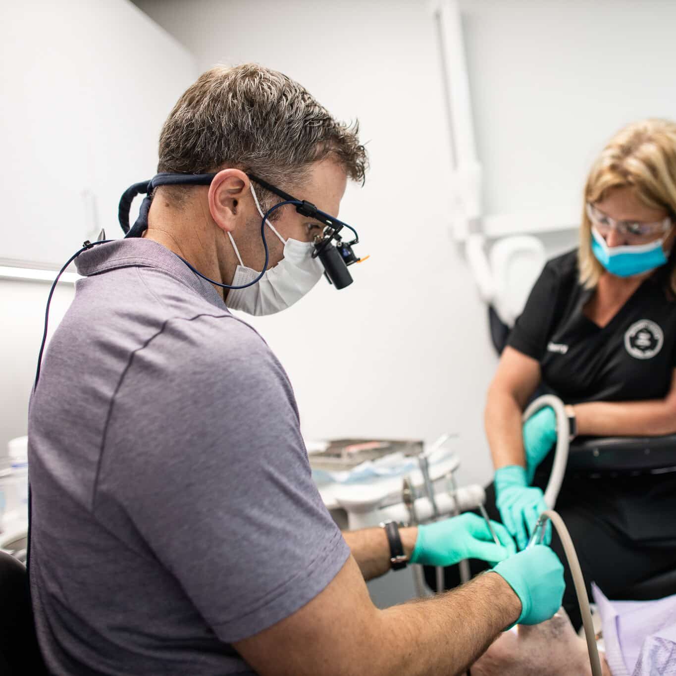 Dentist preparing a patient for dental implants treatment