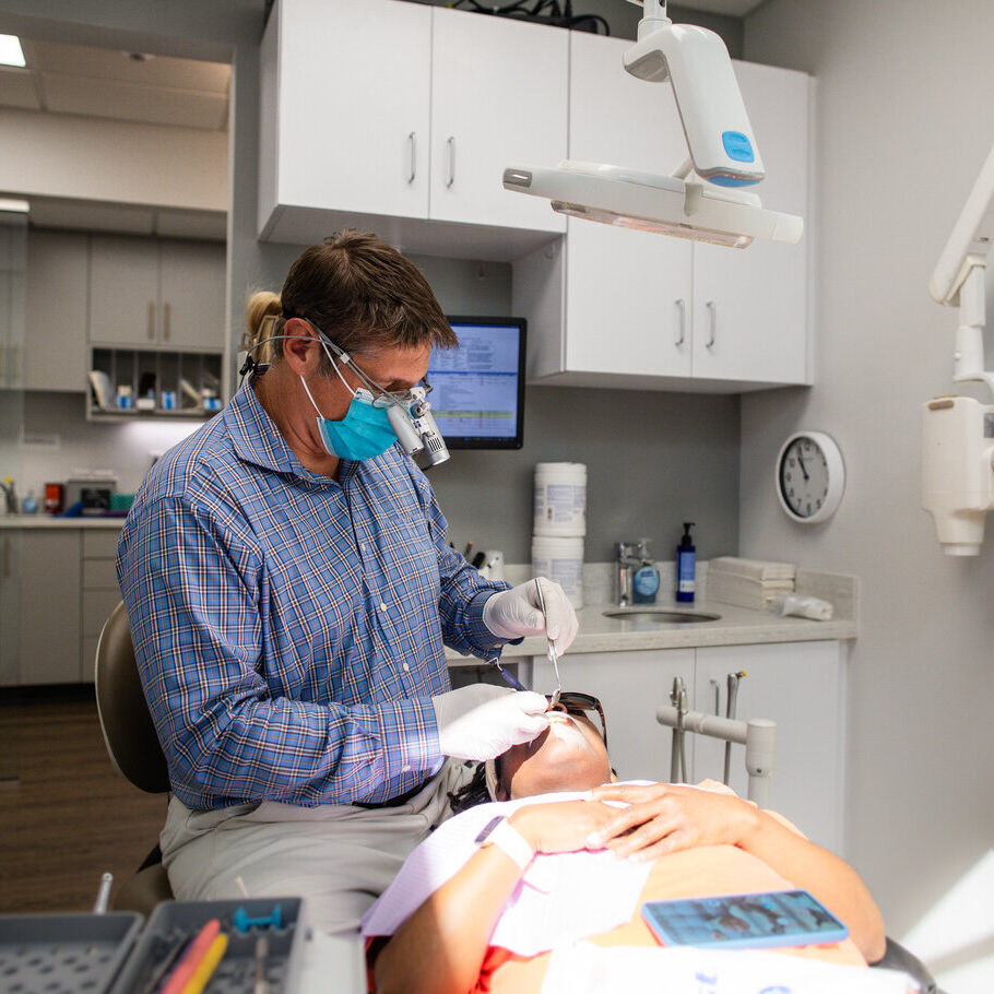 Dentist preparing a patient for dental implants treatment