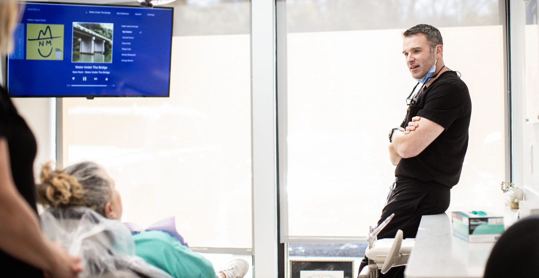 Dr. McKinney talking with a patient during a consultation in a modern treatment room